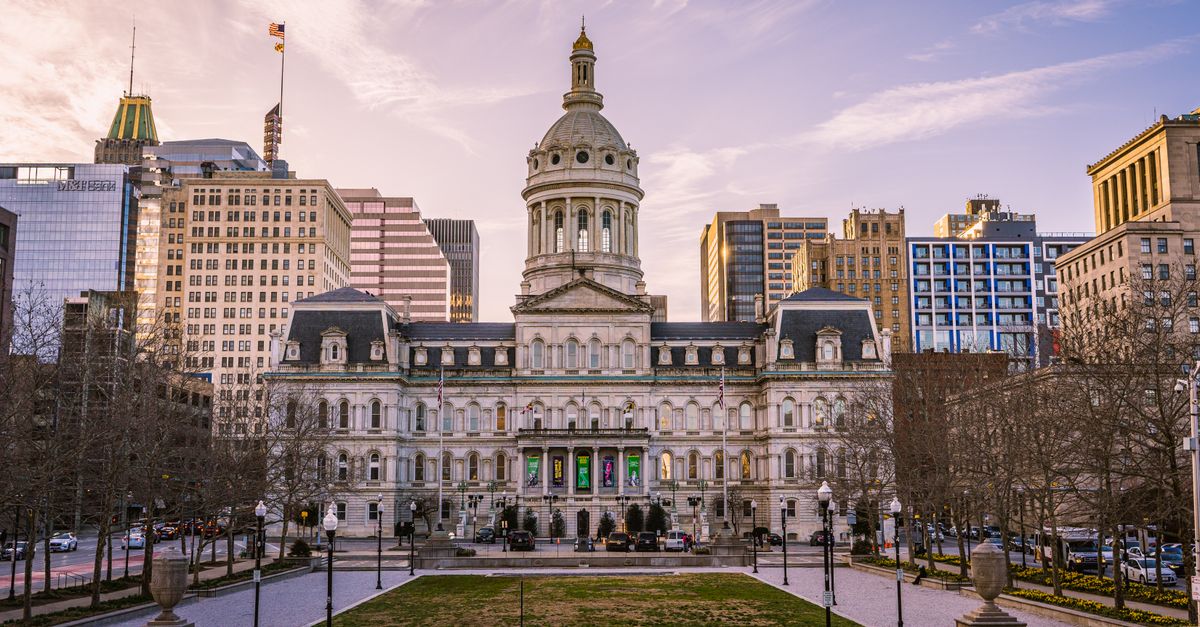 Majestic view of Baltimore City Hall with the city skyline during daytime.